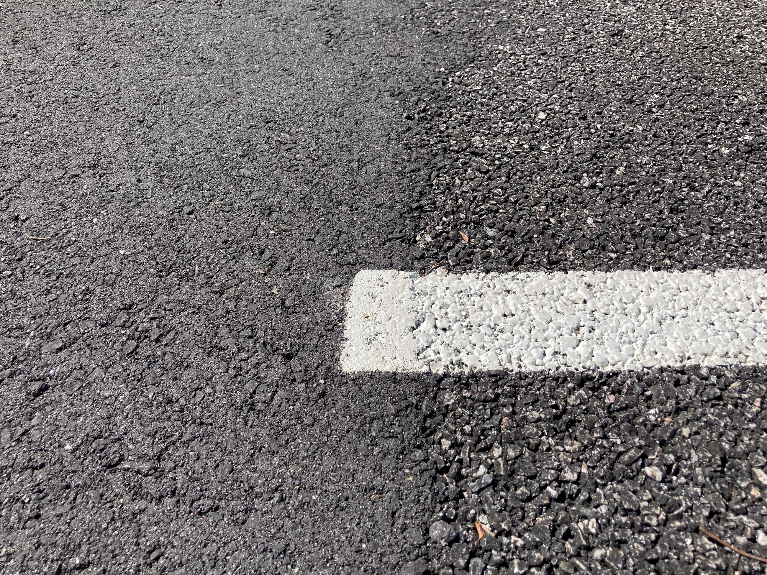Up close picture of permeable pavement next to asphalt